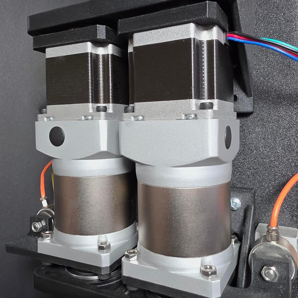 Closeup of a pair of geared stepper motors
